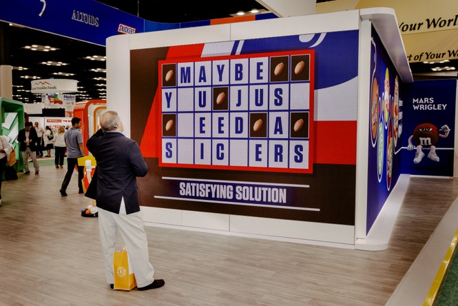 Picture of a man looking at a sign at the Candy Expo.
